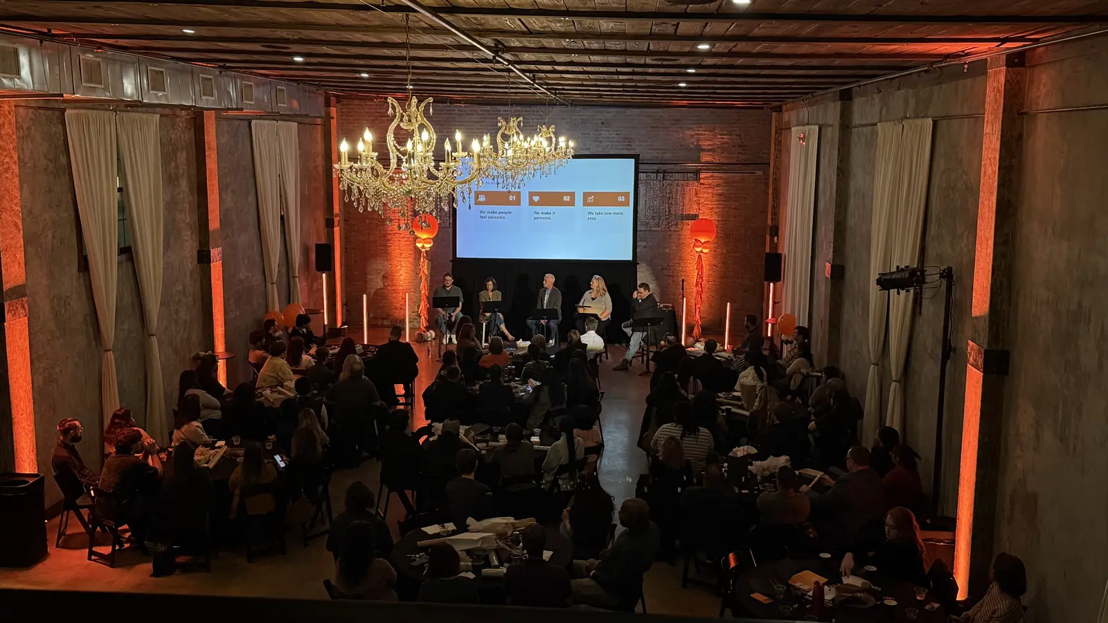 MidFirst Bank employees gathered for a town hall panel with projection and room lighting