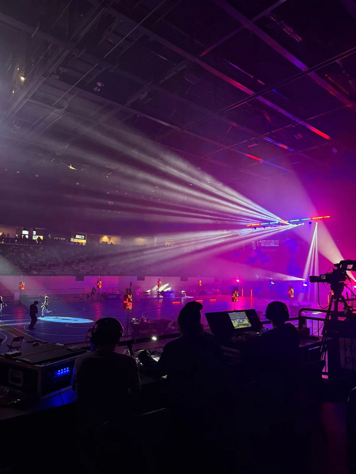 Production crew and lighting looking across the USJOC wrestling mats